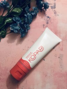 white & red tube of Kopari Coconut Face Cream