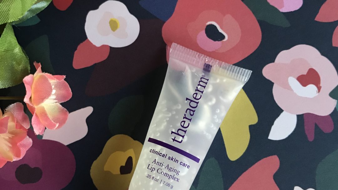 tube of Theraderm Anti-Aging Lip Complex against a flowered background