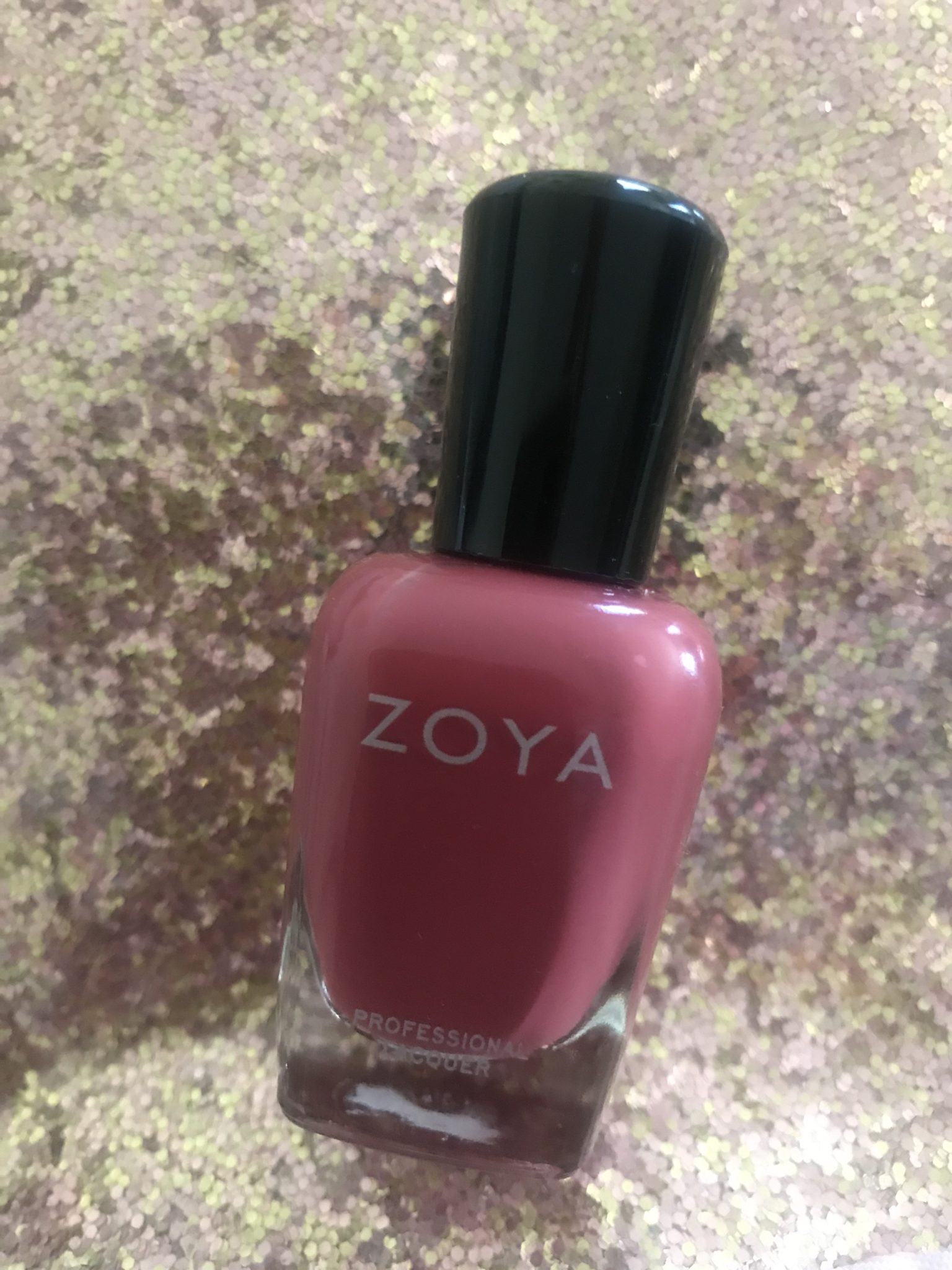 bottle of Zoya "Briar" nail polish, a red terra-cotta cream polish