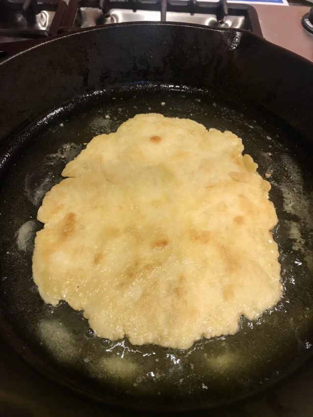 cooking flatbread dough in olive oil
