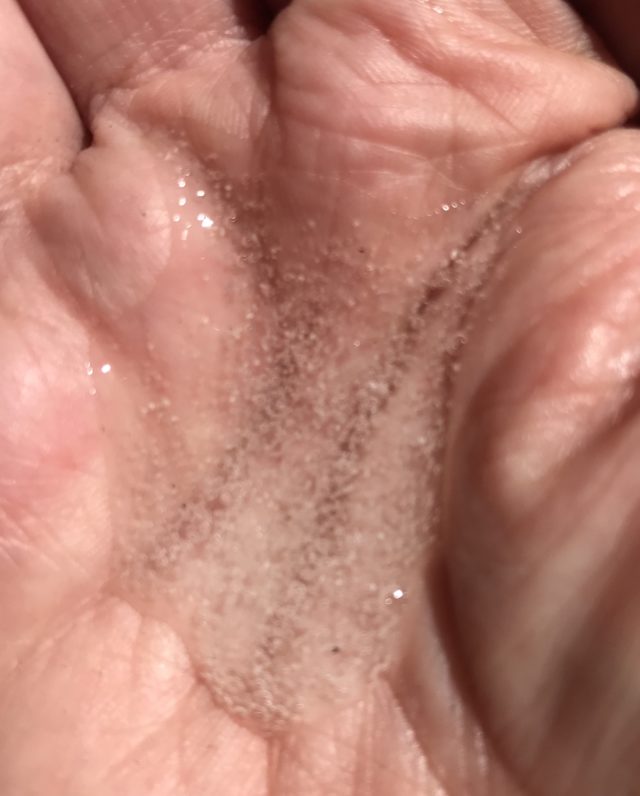 Hemp Seed Hand Wash, a colorless gel with pumice held in my hand