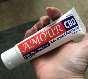 my hand holding a tube of Amour CBD Advanced Pain Relief Cream so you can see the size of the tube