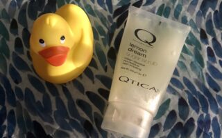 tube of Qtica Smart Spa Lemon Dream Sugar Scrub along with a yellow rubber duck