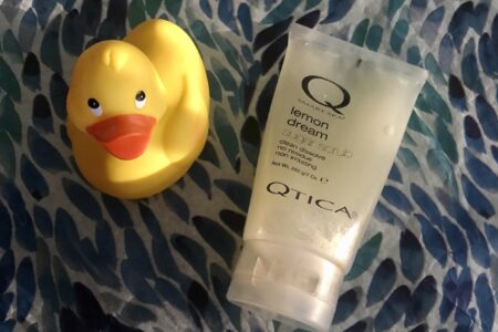 tube of Qtica Smart Spa Lemon Dream Sugar Scrub along with a yellow rubber duck