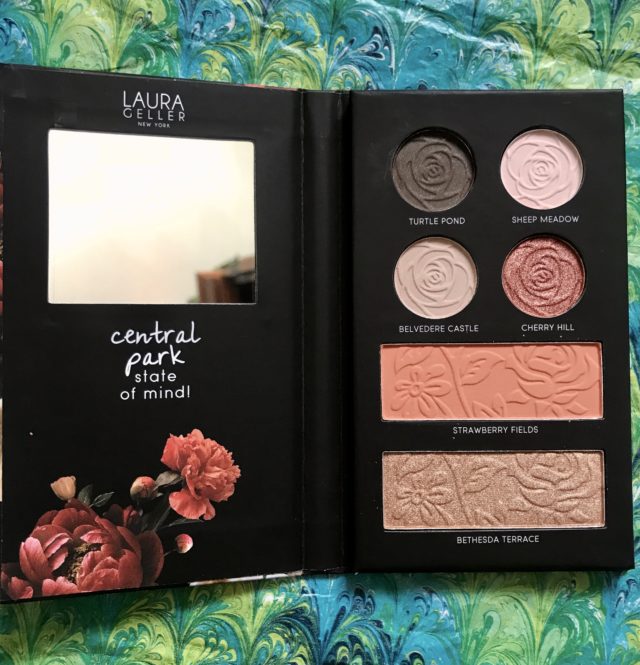 Laura Geller Central Park face palette open to show the mirror and shades of the makeup inside