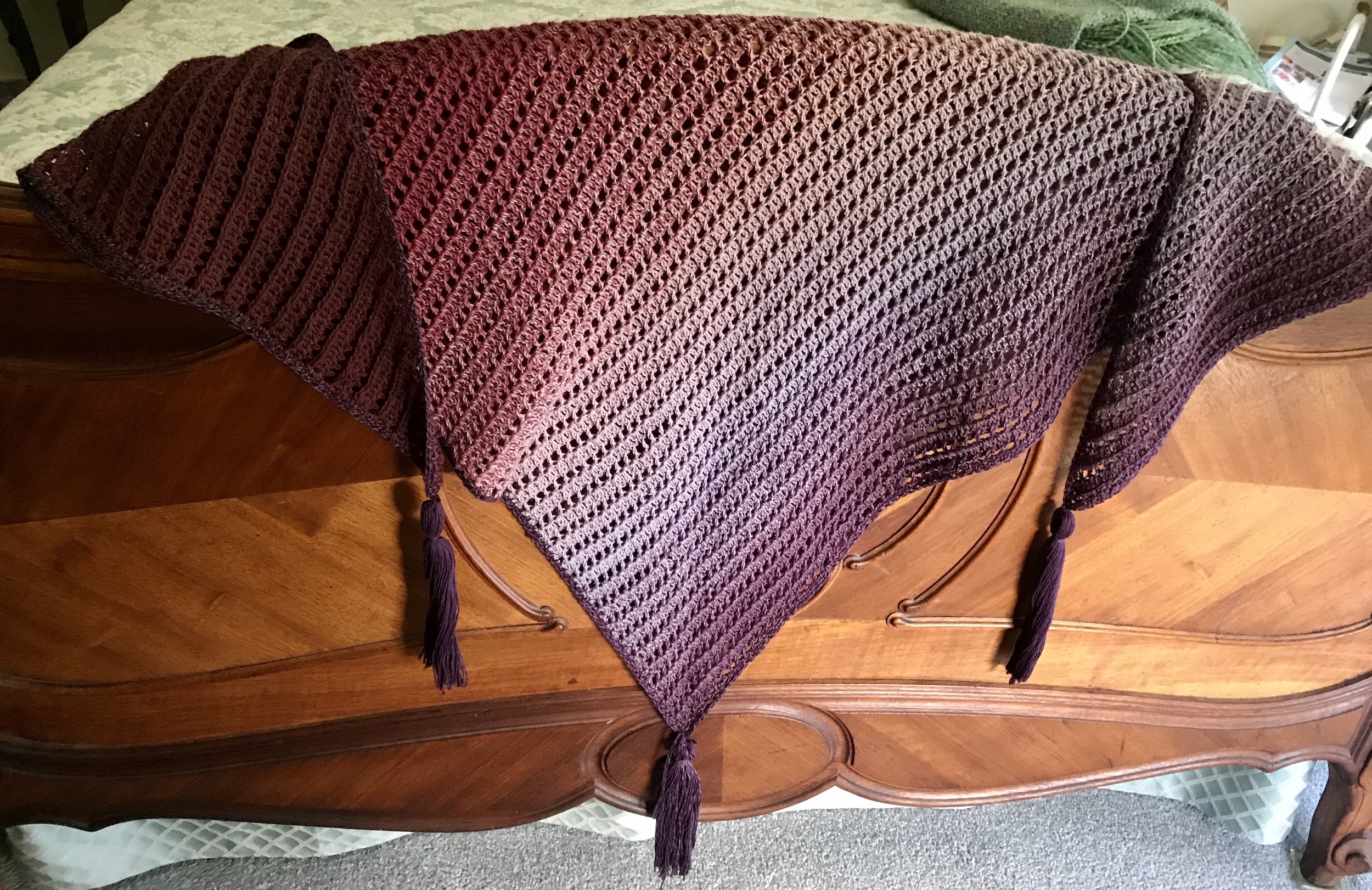 shades of purple Dragon Belly shawl draped over the footboard of my bed