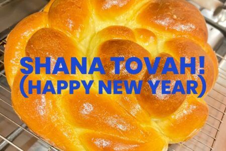 round braided challah with holiday greeting